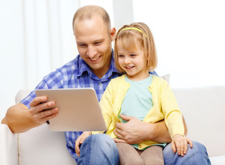 happy father and daughter with tablet pc computer