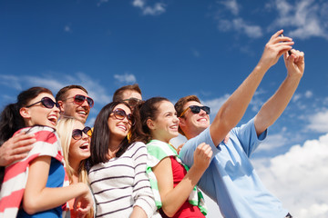 group of friends taking picture with smartphone