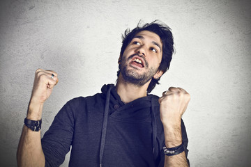 Young casual boy exults