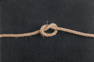  knot of the rope lies on the natural leather