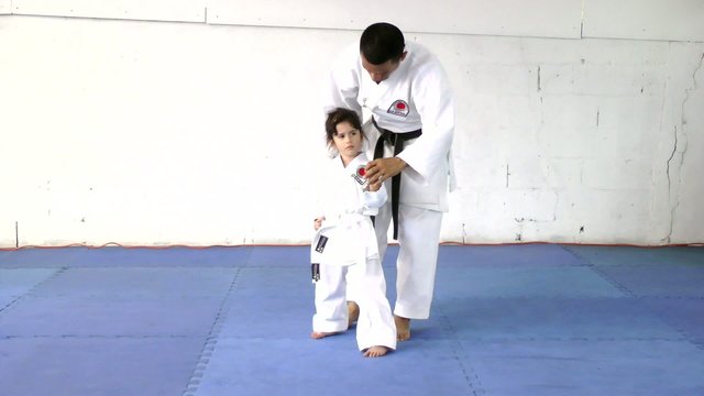Little girl learning from her karate instructor