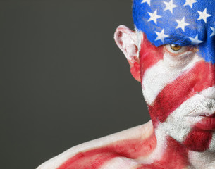 Fototapeta premium Man with his face painted with the flag of USA