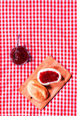 Fresh crusty roll with strawberry jam