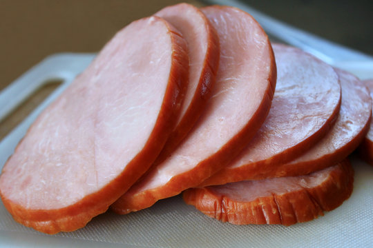 Thick slices of delicious ham on cutting board
