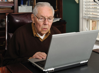 Senior male working on a laptop