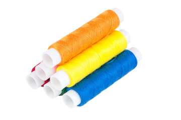 Fototapeta na wymiar Colored spools of threads on white background