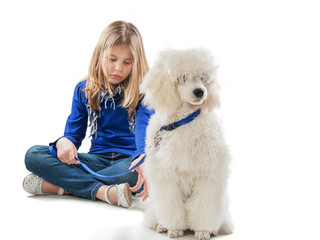 Girl and a white dog sitting