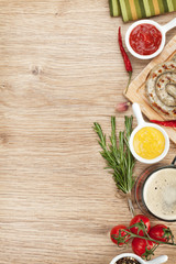 Grilled sausages with ketchup, mustard and mug of beer