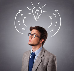 Young man thinking with arrows and light bulb overhead
