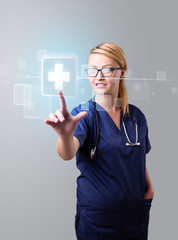 Young nurse pressing modern medical type of buttons