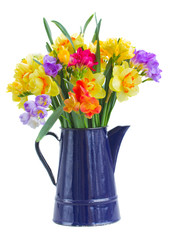 freesia and daffodil  flowers in blue pot