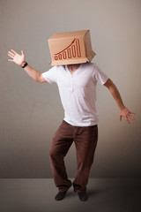 Young man gesturing with a cardboard box on his head with diagra