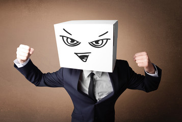 Businessman gesturing with a cardboard box on his head with evil