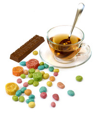 isolated image of a cup of tea and sweets closeup