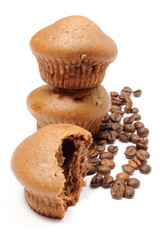 Fresh baked muffins and coffee grains on white background