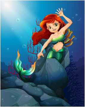 A pretty mermaid trapped with the big rocks under the sea