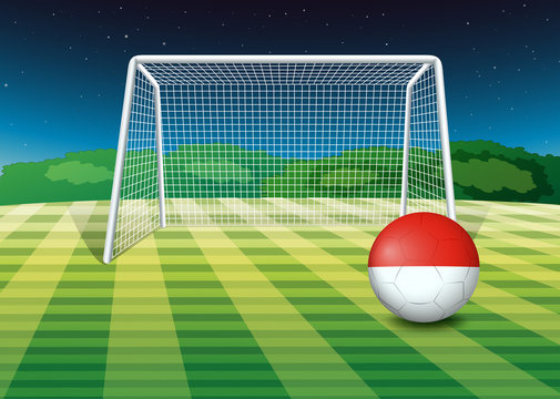 A ball at the soccer field with the flag of Monaco