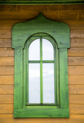 Fototapeta premium Green window on the wooden house