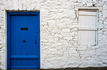blue door and stone work detail of old Irish cottage