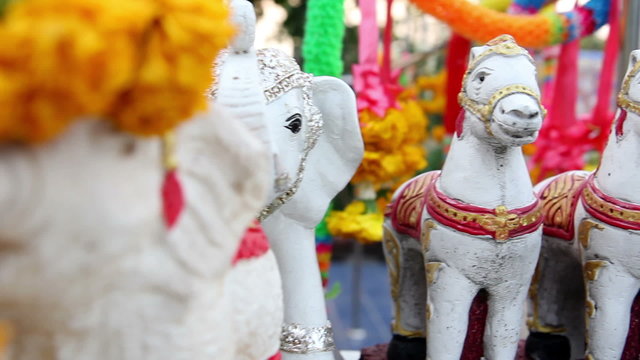 Small animal dolls in front of Buddha statue