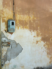 A ruined wall of an old building with broken plaster.