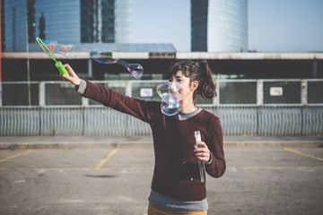 young beautiful hipster woman bubble blower