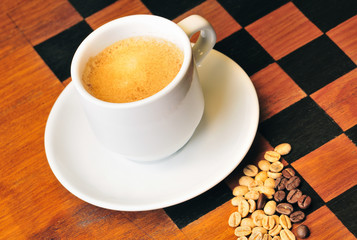 Coffee cup with grains in the wood table