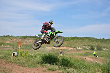 MX rider on the motorbike takes off from the hill © VVKSAM