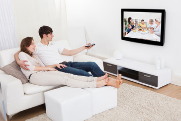 Couple In Livingroom Watching Television