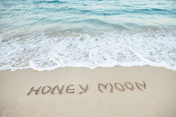Word Honeymoon Written On Beach