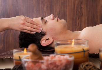 Obraz na płótnie Canvas Man Receiving Head Massage From Massager In Spa