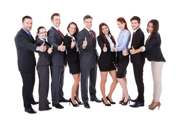 Business people showing thumbs up sign