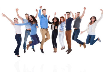 Group of diverse people raising arms and jumping