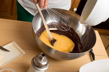 Woman hands mixing chocolate with eggs