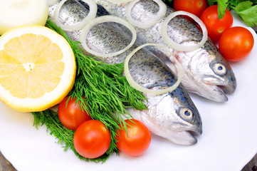 two rainbow trout with lemon and fresh vegetables