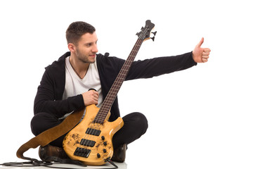 Cheerful musician showing thumb up.