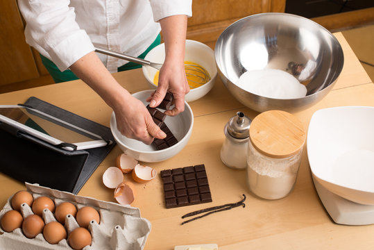Woman hands  make a chocolate cake
