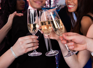 Friends Toasting Champagne At Nightclub