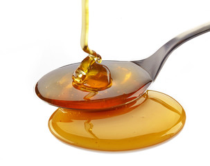 honey pouring into spoon
