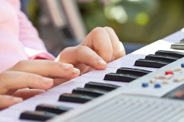 Close-up of hand playing the piano