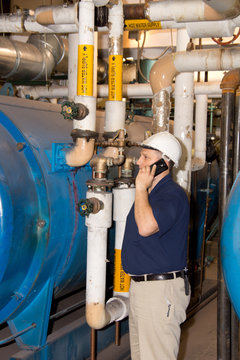 Engineer on phone in power plant