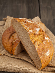 Cut loaf of bread on burlap