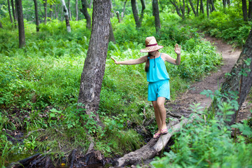 Girl balancing on a log