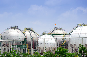 The silver and white huge storage natural gas tanks