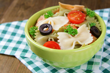 Delicious pasta with tomatoes on plate on table close-up