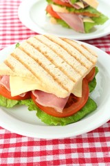 Tasty sandwich with ham on table