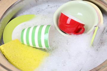 Utensils soaking in kitchen sink