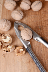 Nutcracker with walnuts on wooden background