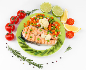 Tasty grilled salmon with vegetables, isolated on white