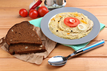 Bowl of tasty fresh hummus with tomatoes